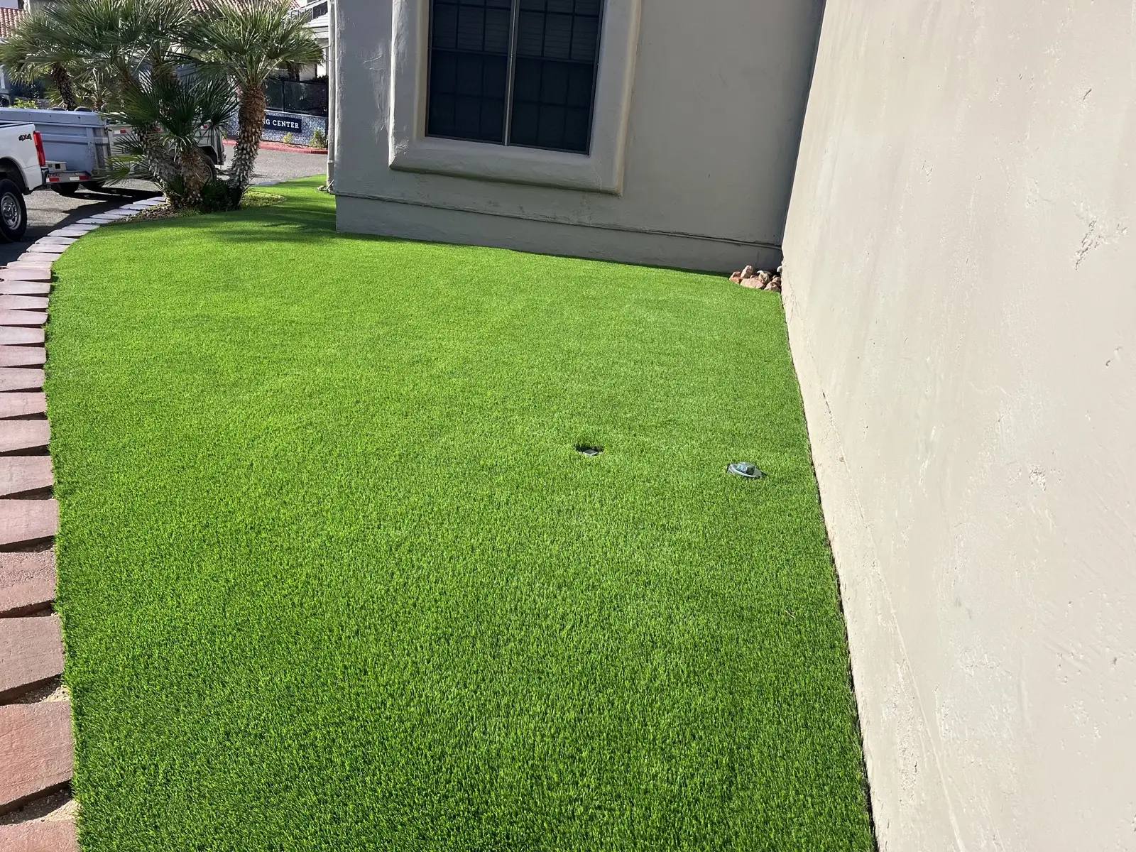 Synthetic turf area installed along a building edge with clean transitions.